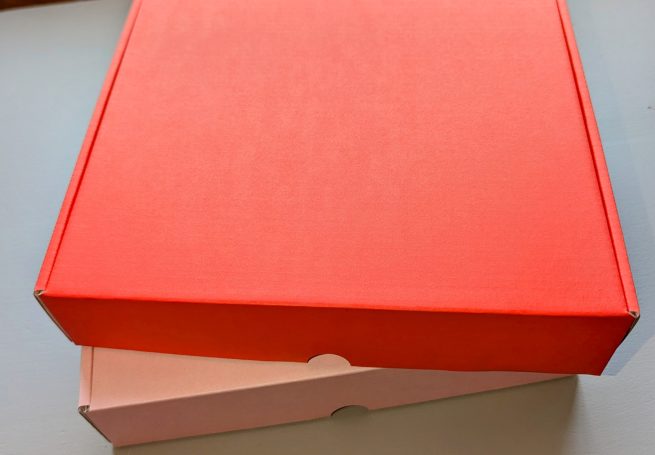 shipping boxes, pink and orangey red