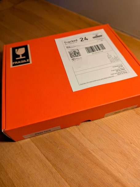 A shipping box with address label and fragile label, ready for posting