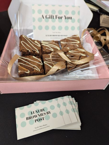 Open box of brownies with gift card